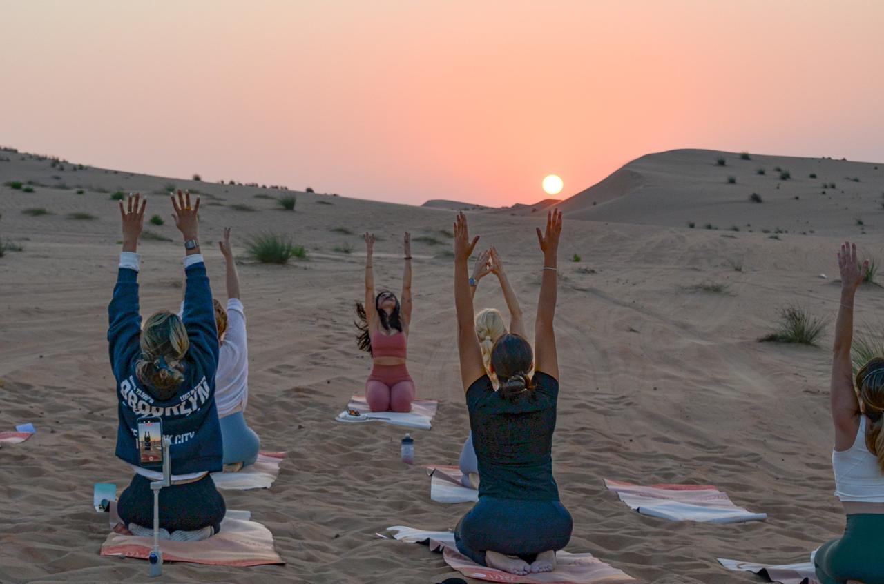 Desert sunset yoga Abu Dhabi — evening practice in the dunes at Al Wathba